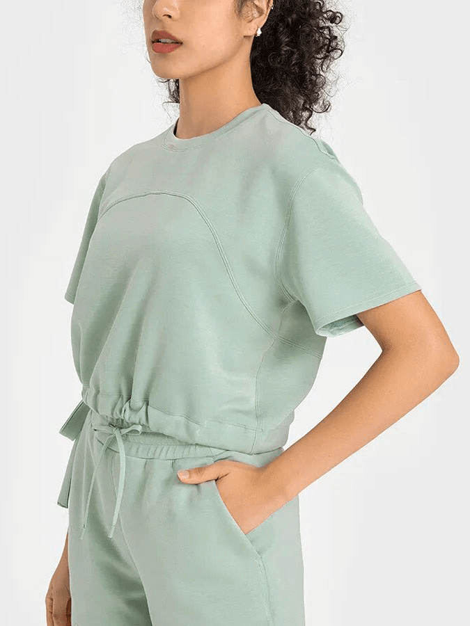 Model wearing mint green sports short sleeves crop T-shirt with adjustable hem, perfect for fitness, running, yoga, and dance.